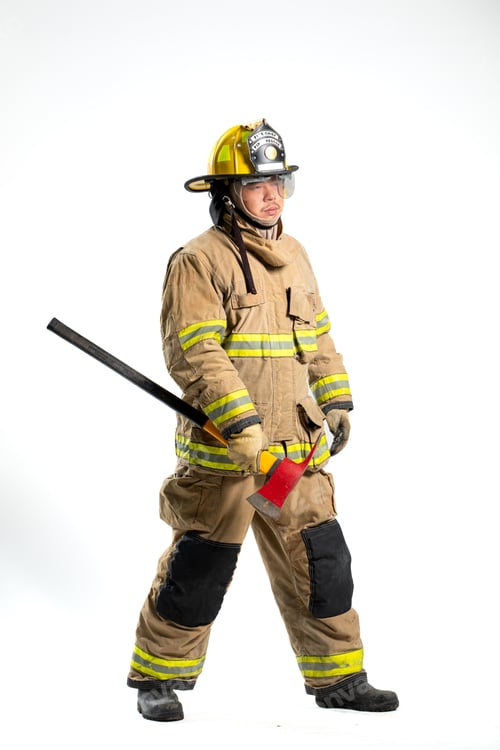 Preview: A firefighter in full turnout gear stands confidently with a rescue axe