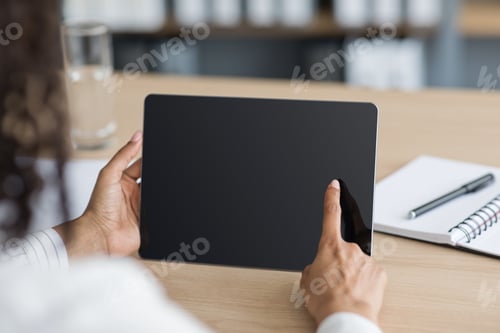 Preview: Business woman working with computer tablet and using gadget for searching information online at
