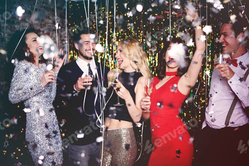 Preview: Group of people dancing and having fun at party, glitter falling through air