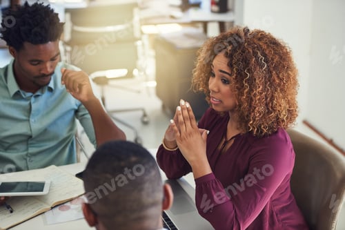 Preview: Cropped shot of a team of designers brainstorming together in an office