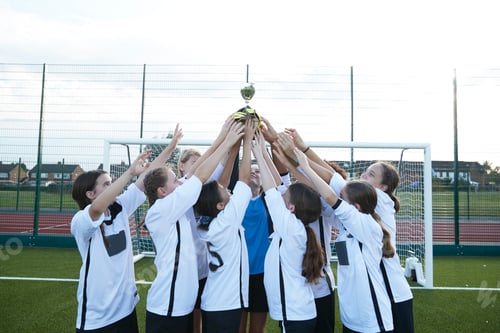Preview: Youth soccer team celebrates victory with a trophy raise