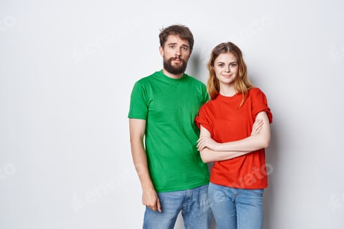 Preview: a young couple hug friendship colorful t-shirts family studio lifestyle
