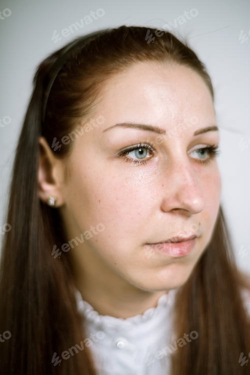 Preview: Portrait of a real young woman in a white shirt with jabot. Shallow depth of field. Focus on the