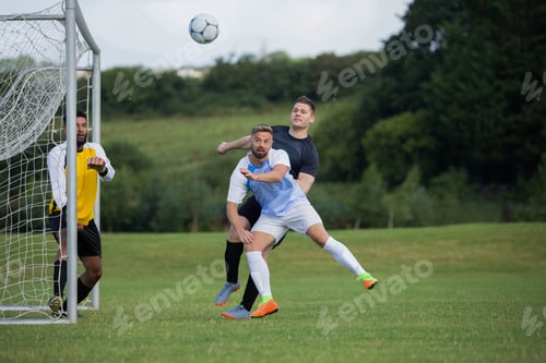 Preview: Football players playing soccer in the ground