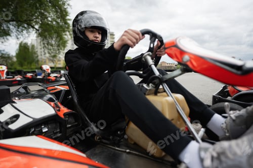 Preview: Go-Kart Racing Action With Focused Driver In Black Helmet