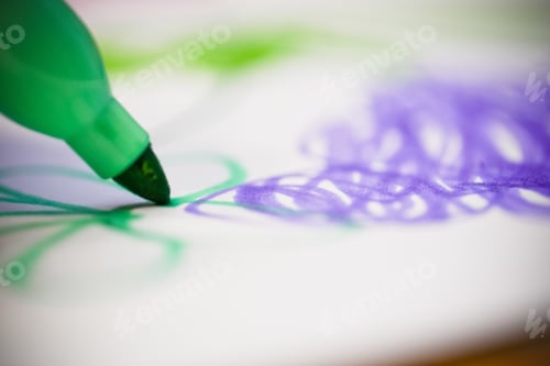 Preview: Selective focus closeup photography of a colorful green marker drawing on a white paper