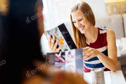 Preview: Two beautiful women looking at menu