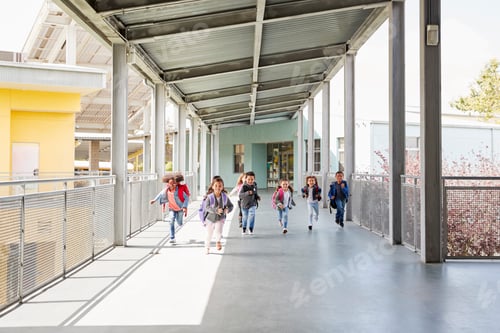 Preview: Young school kids running on a walkway in their school