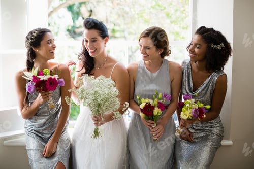 Preview: Bride and bridesmaids standing with bouquet