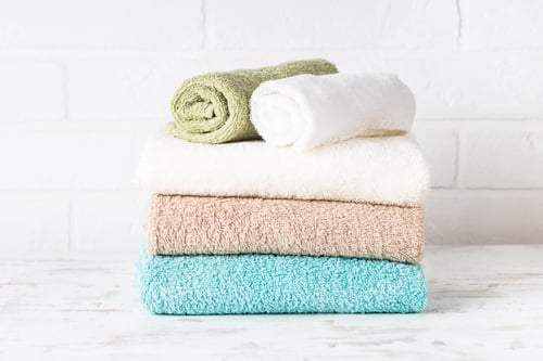 Preview: Stack of bath towels in white bathroom.