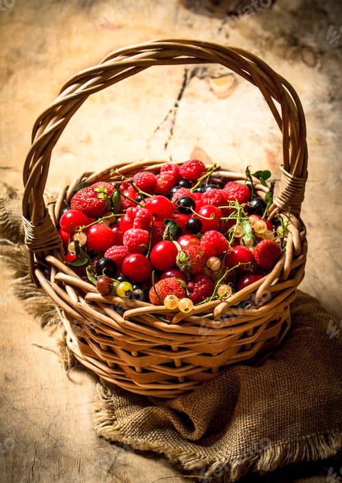 Preview: Basket with berries. On wooden table.