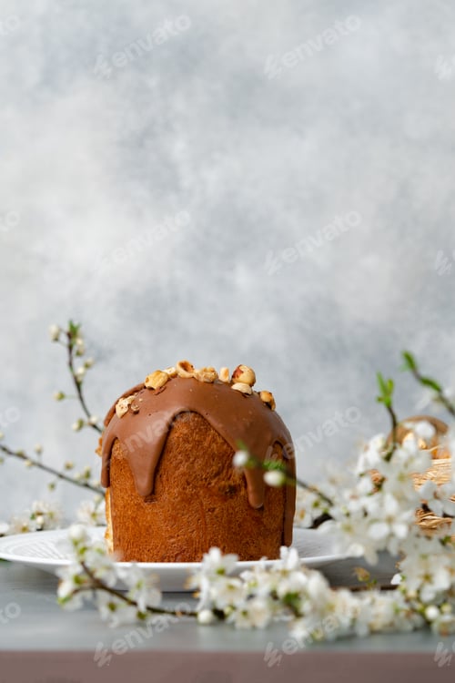 Preview: Cut Easter cake on plate decorated with spring flower branches