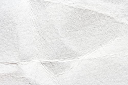Preview: Abstract textured white paper background with creases and folds