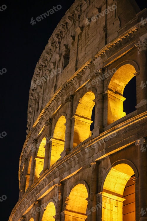 Preview: Iconic Coliseum of Rome, Italy illuminated by the lights at night