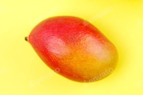Preview: Orange ripe mango yellow background