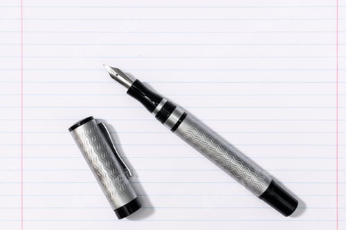 Preview: Fountain pen on blank lined paper background