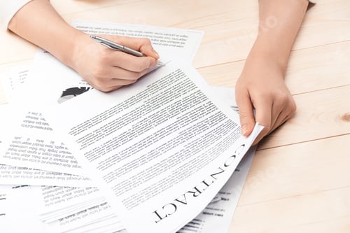 Preview: cropped view of businesswoman signing contract documents sitting at table
