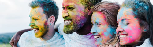 Preview: panoramic shot of woman smiling near multicultural friends with holi paints on faces
