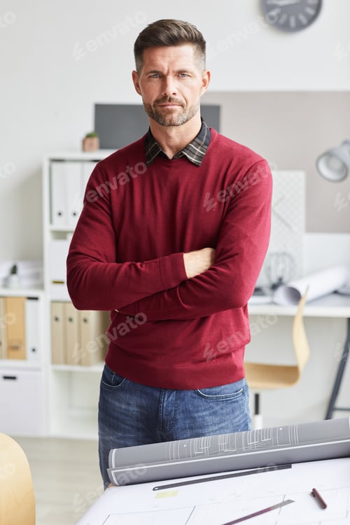 Serious Man Standing with Arms Crossed in Office