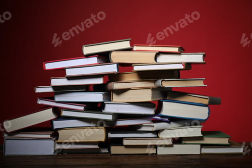 Preview: Many books on table against red background