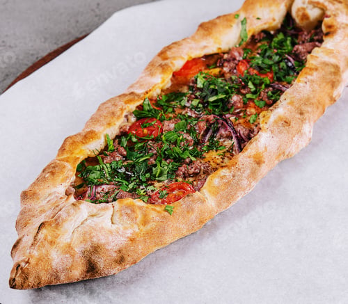Preview: traditional turkish meat pide on wooden board
