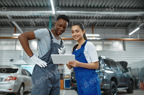 Preview: Male and female mechanics, car service
