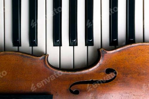 Preview: old violin on piano keys