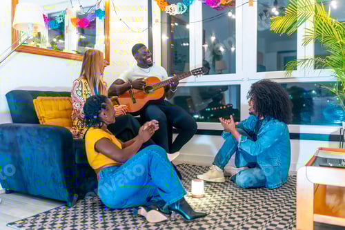 Preview: Multi-ethnic friends playing guitar at home at night