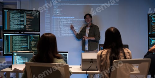 Preview: Asian man presenting code with projector in software development meeting