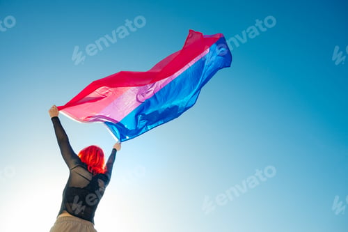 Preview: Beautiful low angle shot of a female waving red and blue flag