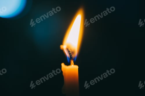 Preview: Candle light with fire in the dark as a hope in sorrow