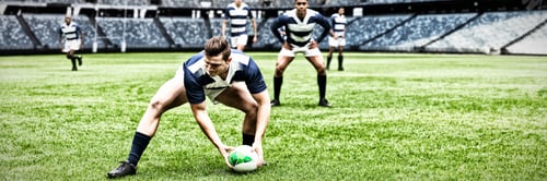 Preview: Digital composite image of rugby player picking up the ball in sports stadium