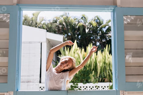Preview: Inspired cute girl dancing on nature background with happy smile. Photo of adorable tanned woman wi
