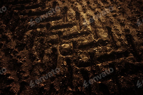 Preview: Closeup of the ground in a potato field with large tractor trails left in the soil