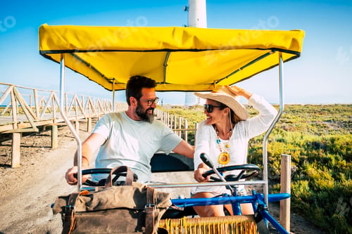 Preview: Cheerful caucasian couple enjoying vacation while riding cart. Happy couple traveling