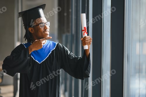 Preview: Proud graduate pointing at diploma celebrating university achievement