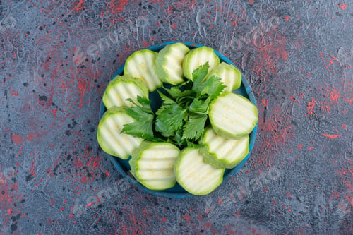 Preview: Sliced zucchini with herbs in a blue plate