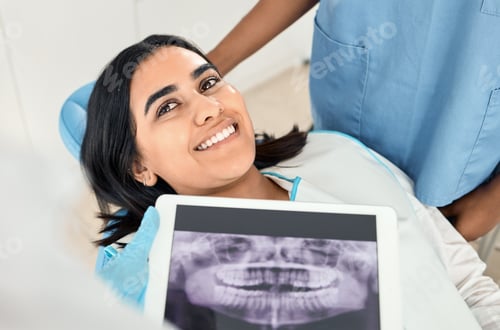 Preview: Shot of a dentist looking over a patients x-rays before a procedure
