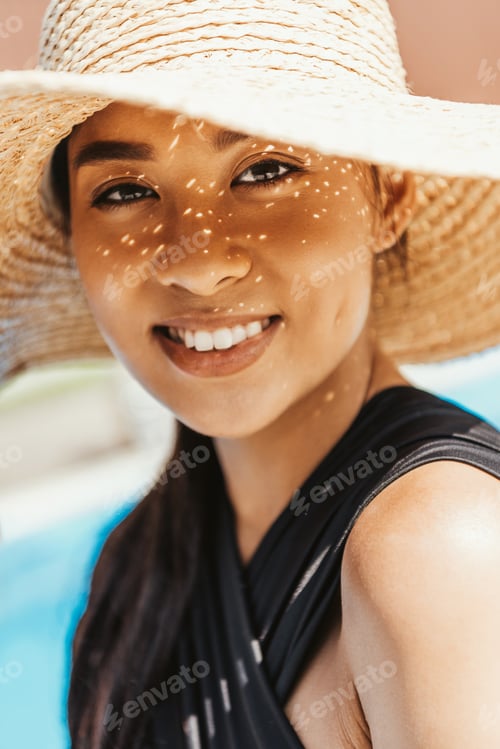 Preview: portrait of smiling asian girl in swimsuit and straw hat