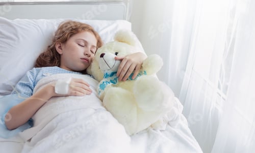 Preview: Little caucasian girl not well recover lying in hospital bed with teddy bear