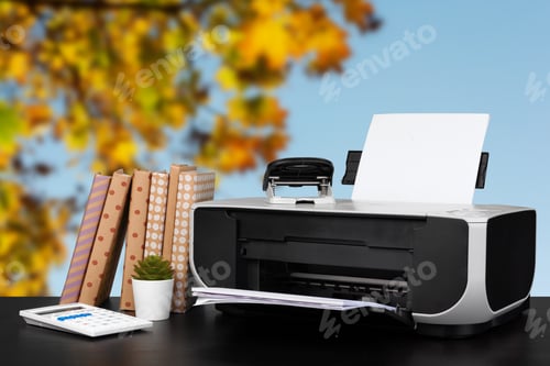 Preview: Compact home printer on desk with books against blurred background
