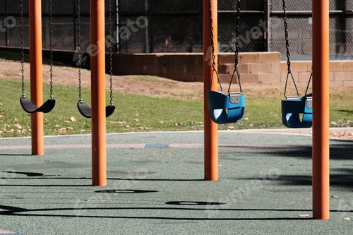 Preview: Empty swingset on a sunny playground