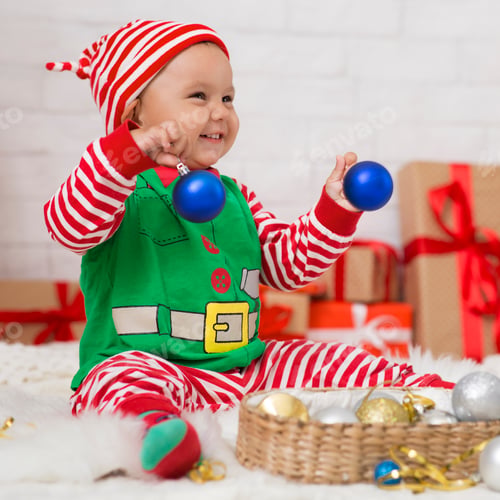 Preview: Happy baby elf enjoying Christmas home decoration