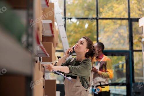 Preview: Storage room worker talking at landline phone