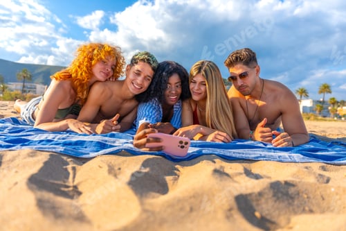 Preview: Happy friends taking selfie on beach towel enjoying summer vacation