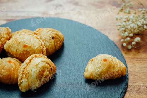 Preview: Closeup of curry puffs on stone dinnerware
