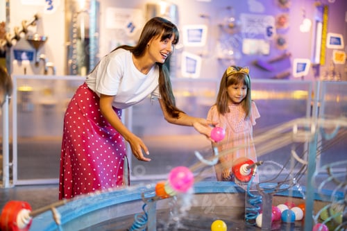Preview: Mom with kids playing in a science museum