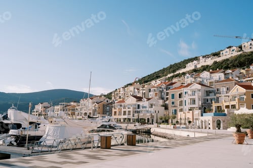 Preview: Embankment of the Lustica Bay with moored yachts and multi-colored clubhouses