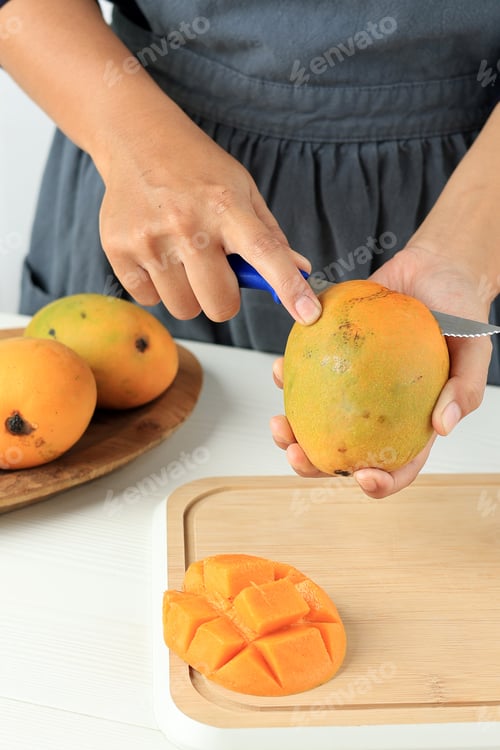 Preview: Woman Cutting Peeling Ripe Mango