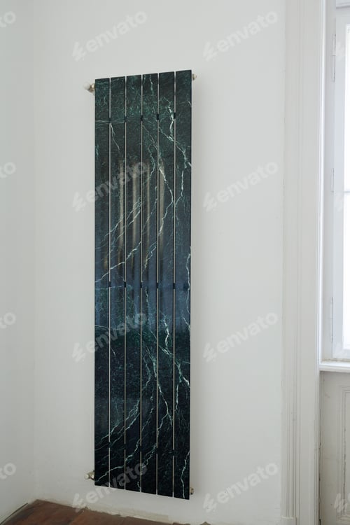 Preview: Modern heating battery installed on wall during reconstruction of house. Stylization of green marble